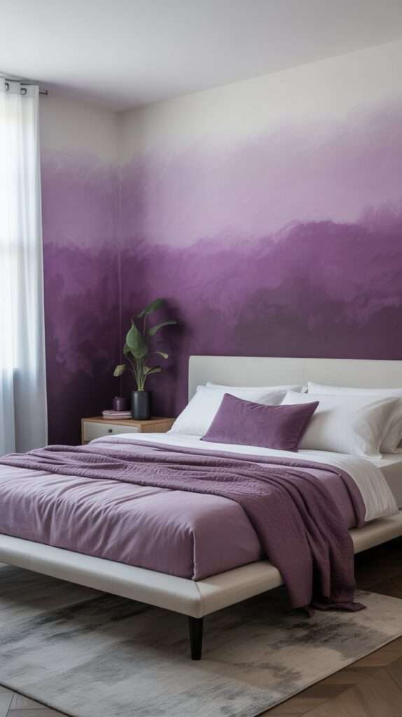 Purple ombre accent wall fading from lavender to deep plum behind a modern white bed, simple nightstand and clean minimalist décor.